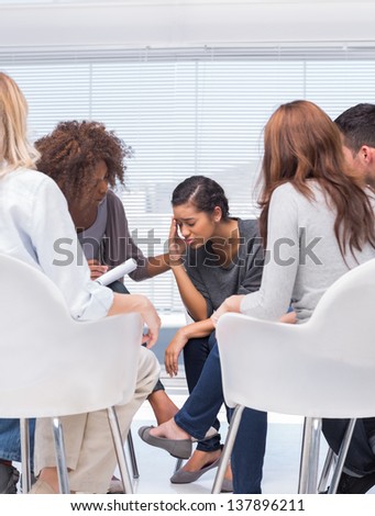 Therapist encouraging a patient at group therapy