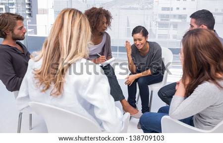Woman sitting on chair and getting depressed in group therapy