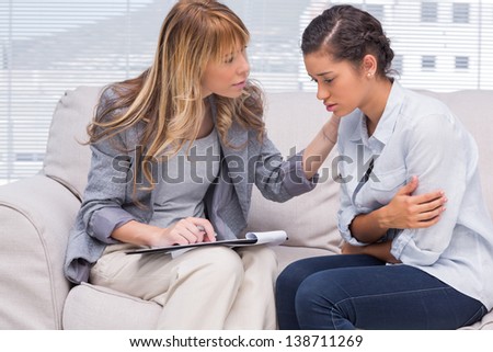Therapist Comforting A Patient At Office