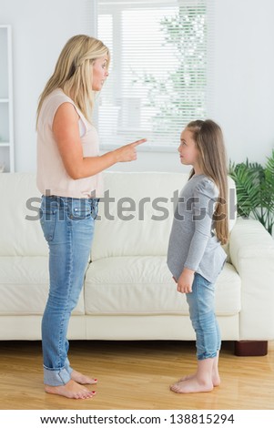 Mother scolding daughter in the living room