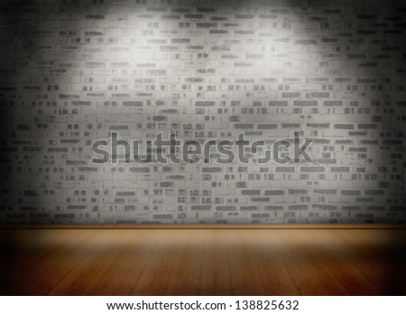Room with wooden floor lighted with spotlights with grey brick wall