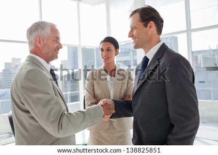 Businesswoman introducing colleagues together in their office
