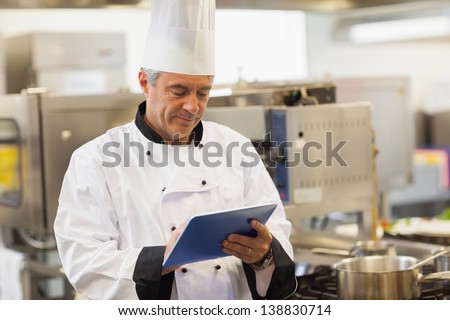 Chef Using His Digital Tablet In The Kitchen