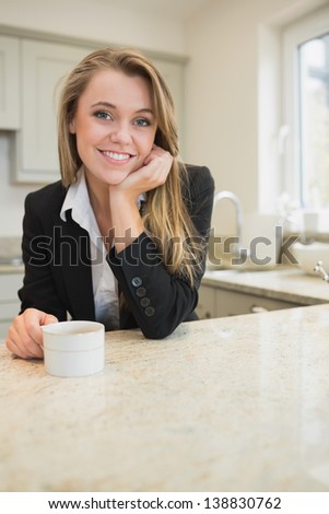 Woman drinking coffee at morning in kitchen