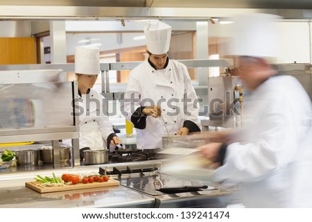 Busy Chefs At Work In The Restaurant Kitchen