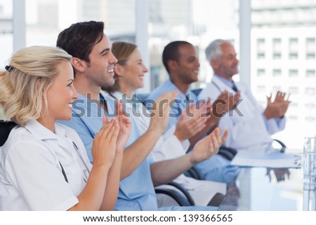 Medical team clapping  their hands during a meeting