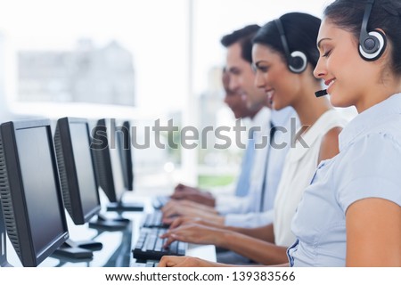 Call centre workers working in line with their headsets
