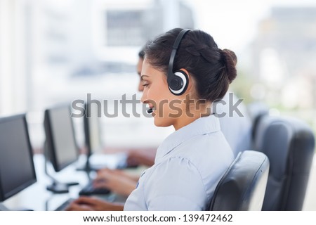 Attractive Brunette Working In A Call Centre With Her Headset