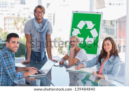 Team having meeting about recycling in bright office