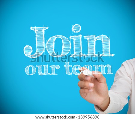 Businesswoman writing join our team on blue background with a chalk