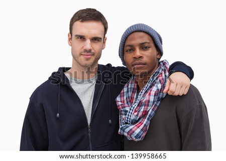 Two fashionable friends looking at camera on white background