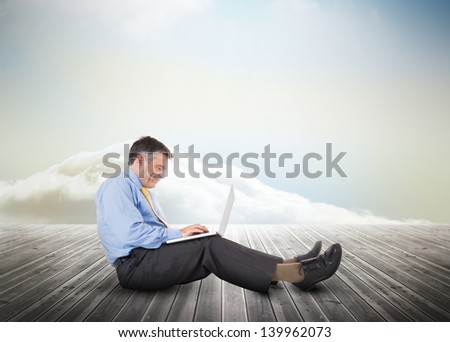 Laying businessman over wooden boards leading out to the horizon