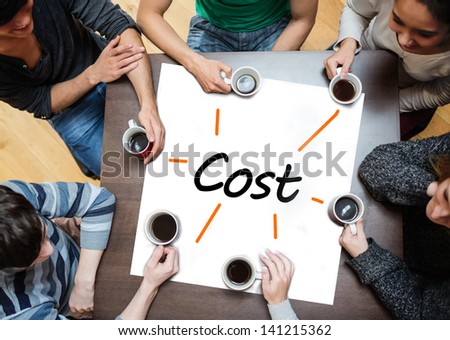 Team brainstorming around a table over a poster with cost written on it