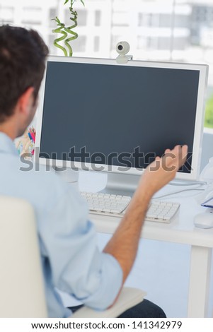 Designer having a video chat in his office on his computer