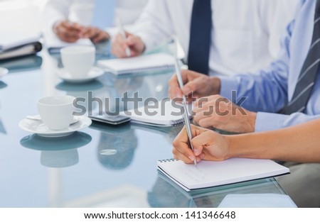 Business people hands taking some notes during a meeting