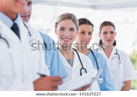 Smiling medical team in row in a hospital
