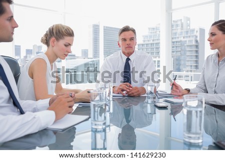 Serious businessman during a meeting with his employees