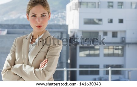 Businesswoman with arms folded in her modern office