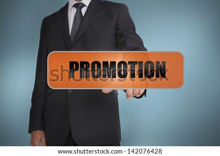 Businessman touching the word promotion written on tag on blue background