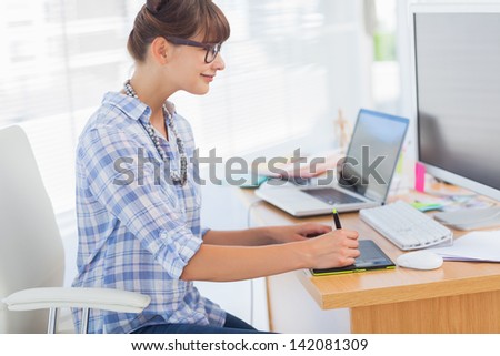 Designer working on her graphics tablet in her office
