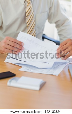 Hands of businessman turning a page in the office