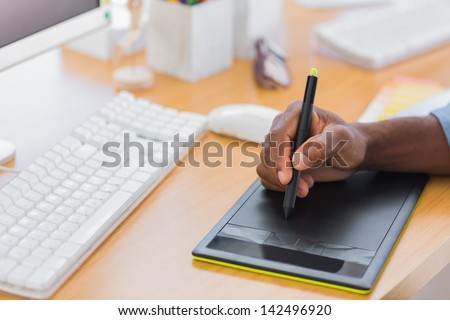 Close up of a graphic designer using graphics tablet in a modern office