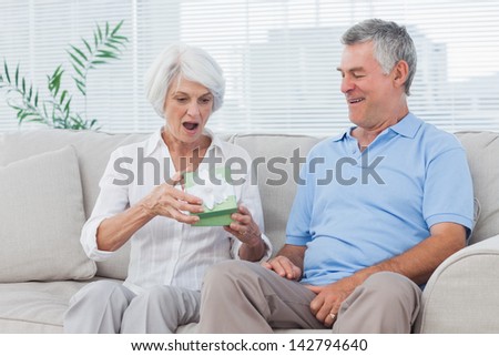 Mature man giving a gift to wife
