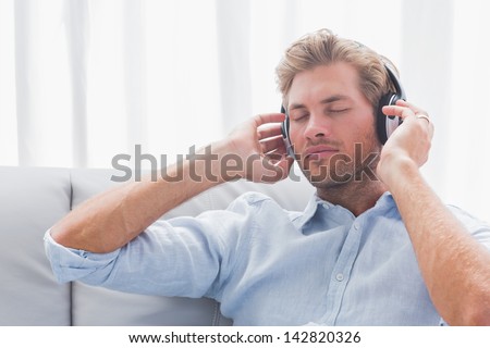 Calm man listening to music on a couch