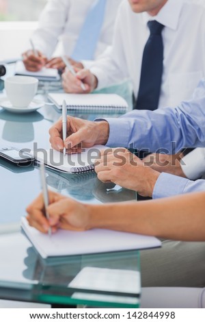 Business people hands taking notes during a meeting