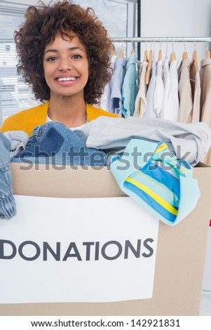 Attractive woman participating at charity and holding donation box