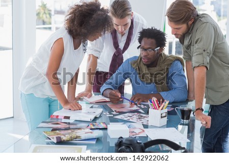 Team of photo editors having brainstorming session in their office