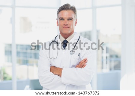 Grey haired doctor with arms crossed