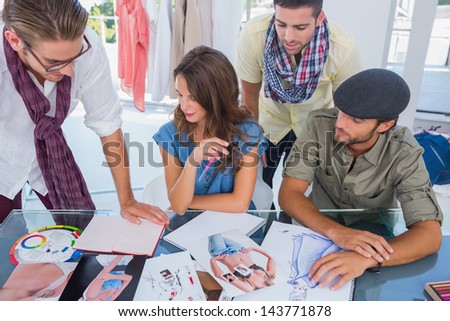 Group of designers working with photos and magazines