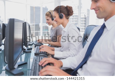 Call centre employees at work on computer in office