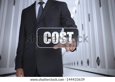 Businessman in a data center selecting label with cost written on it