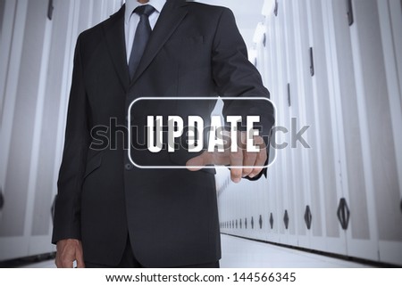 Businessman touching a label with update written on it in a data center