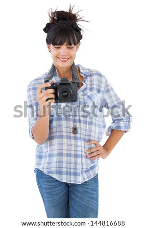 Young woman with hand on her hip taking picture on white background