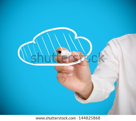 Businessman drawing a white cloud on blue background