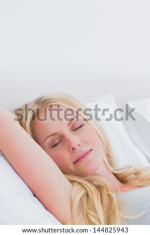 Attractive woman sleeping in her bed