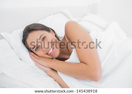 Beautiful woman resting in bed in the bedroom