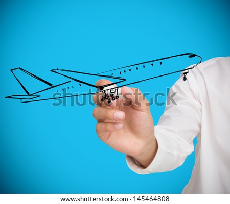Businessman drawing black airplane on blue background