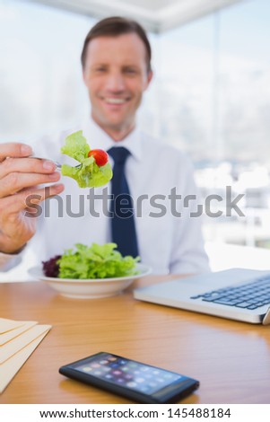 Businessman eating a salad during the lunch time