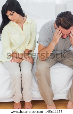 Couple sulking after dispute in bedroom