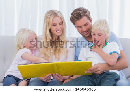 Happy family reading a story together on the couch