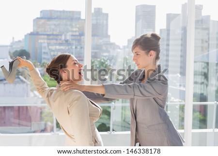 Businesswomen having a massive fight in a bright office