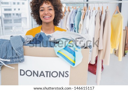 Woman participating at charity and holding donation box