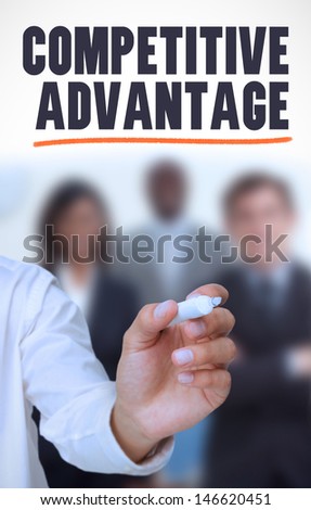 Businessman underlining the word competitive advantage in front of a business team