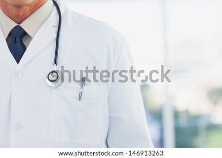 Doctor wearing lab coat in a bright office