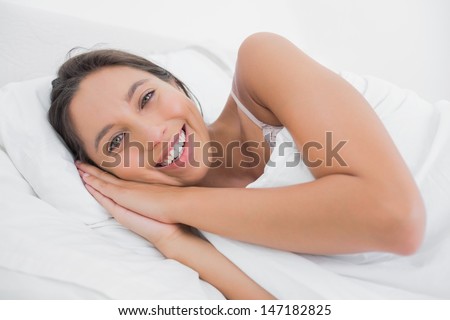 Pretty woman resting in bed in the bedroom