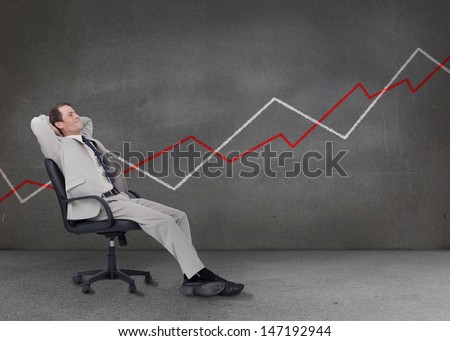 Businessman relaxing on a chair with white and red chart on the background